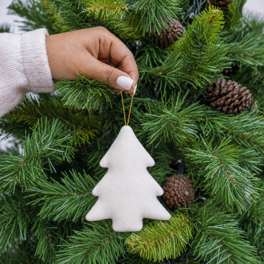 White plush fabric Christmas tree shape decoration with gold hanging string being hung on a Christmas tree - wholesale blank for sublimation, HTV and DTF, KWC8852
