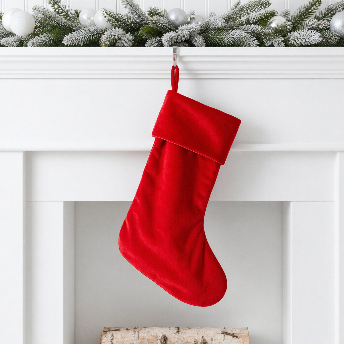 Red plain velvet Christmas stocking with self fabric hanging loop on a white mantelpiece with frosted garland - wholesale blank for sublimation, embroidery, HTV and DTF, KWC8854R