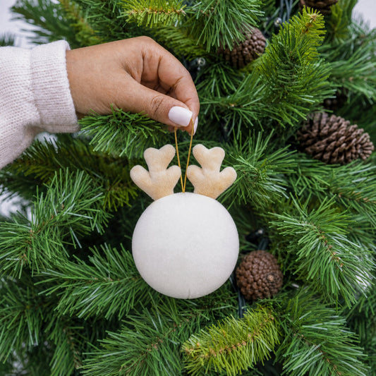 White plush reindeer bauble decoration with antlers and gold hanging string being hung on a Christmas tree - wholesale blank for personalisation, KWC4878