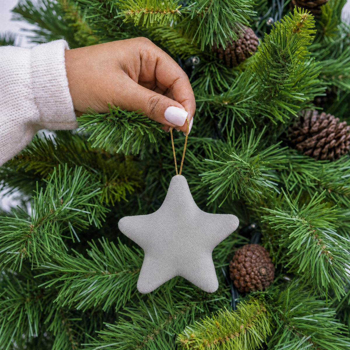 Grey plush fabric star shape Christmas decoration with gold hanging string being hung on a Christmas tree - wholesale blank for personalisation, KWC2407G